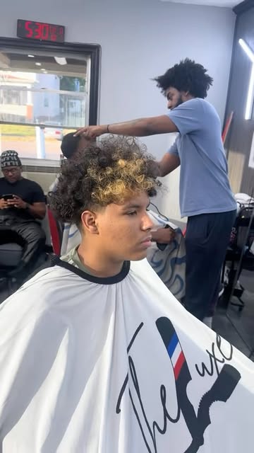 Curly top being shaped in the chair at The Luxe