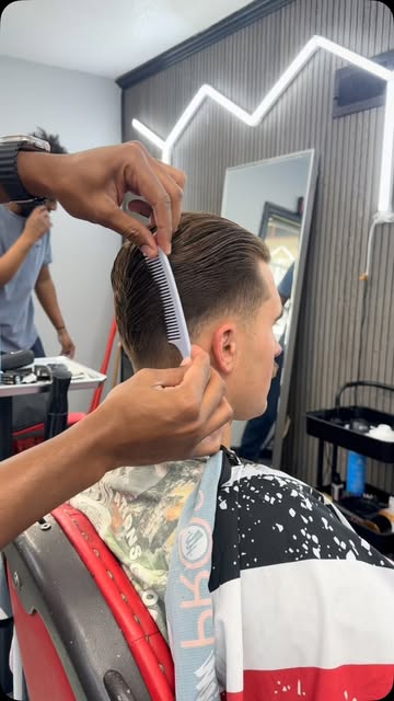 Barber combing out a fresh cut at The Luxe